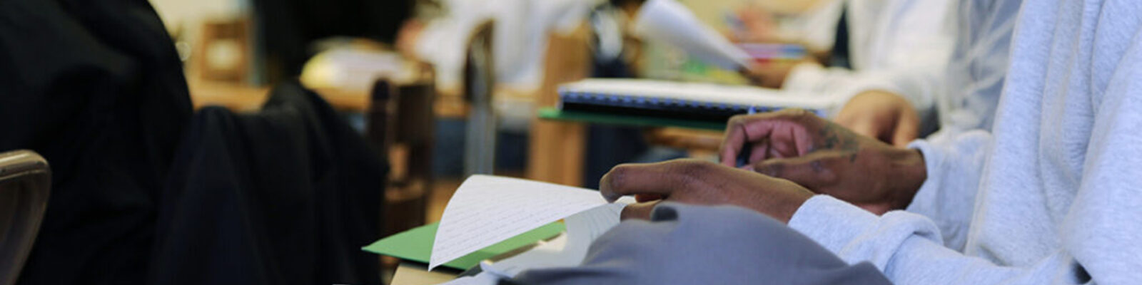 A closeup of a student working at their desk