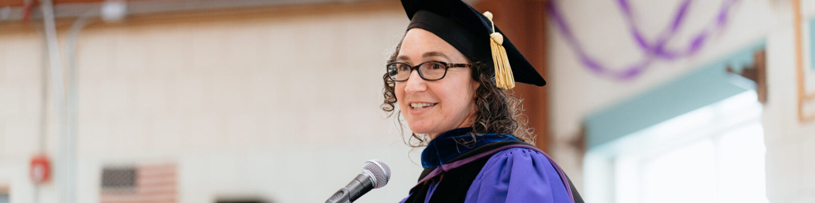 Mneesha Gellman addressing the audience at the 2025 Emerson Prison Initiative commencement ceremony